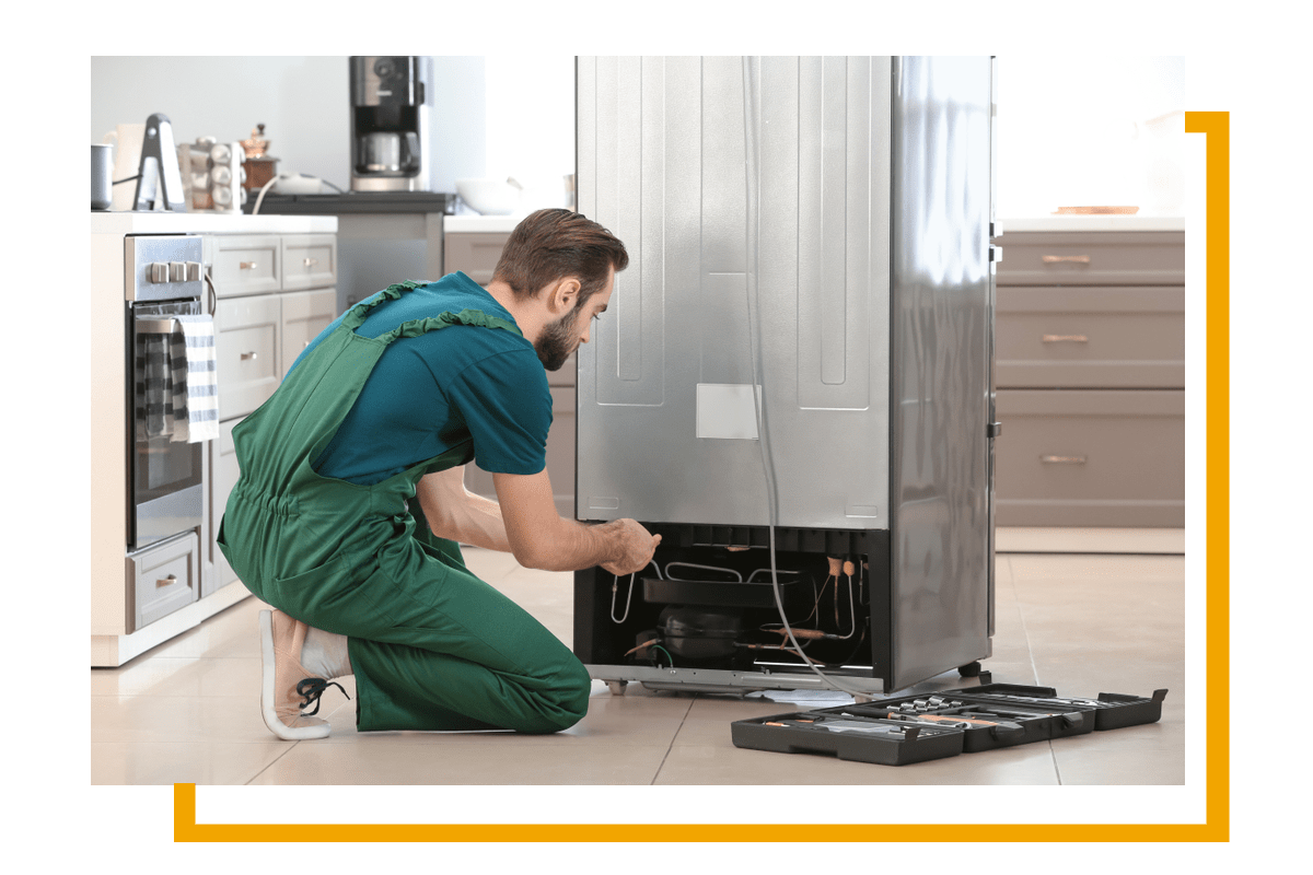 Atlanta City Appliance Repair technician repairing appliances in Alpharetta GA Appliance Repair in Alpharetta, GA and North Atlanta- repairman fixing the refrigerator